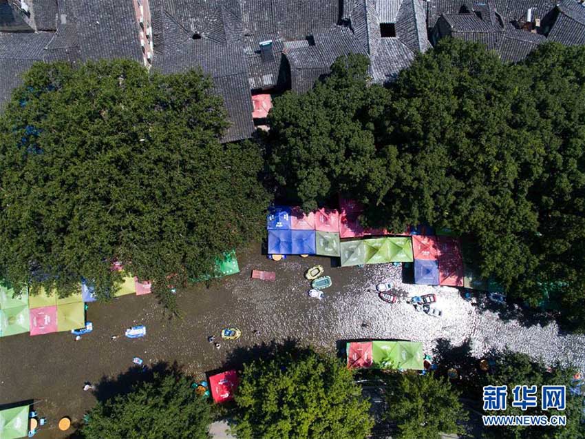 厳しい殘暑が続く重慶、涼を求めて水辺に集まる人々