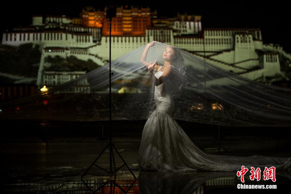 寒さをものともせず冬の夜にポタラ宮で撮影する観光客たち　チベット