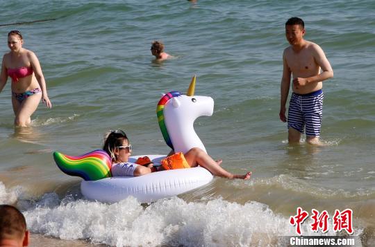 中國(guó)の北方では寒気到來(lái)、海南省は海水浴客でにぎわう