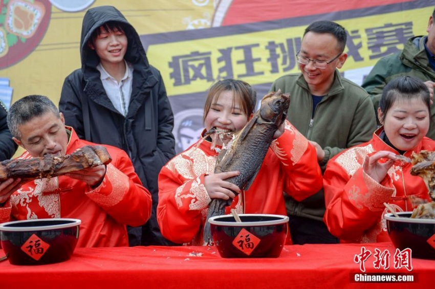 燻製食品大食い大會で王座目指し燻製魚にかぶりつく女性　中國
