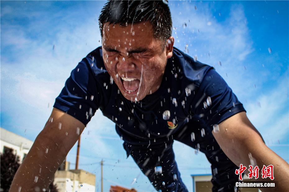 腕立て伏せをして滝のような汗を流す森林消防員（撮影?張広魁）。