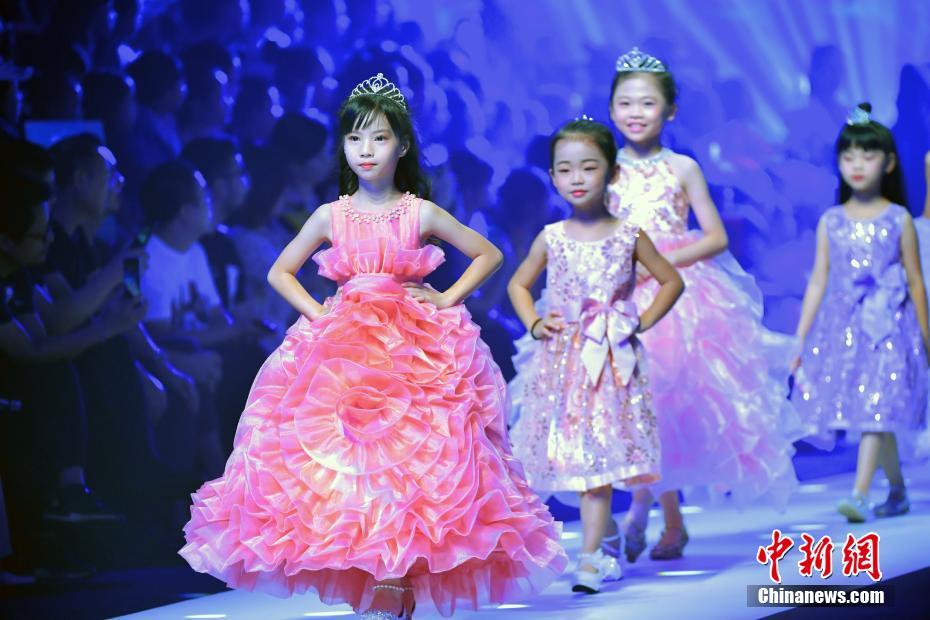 ドレスのファッションショーでランウェイを歩くキッズモデル（7月17日撮影?陳文）。
