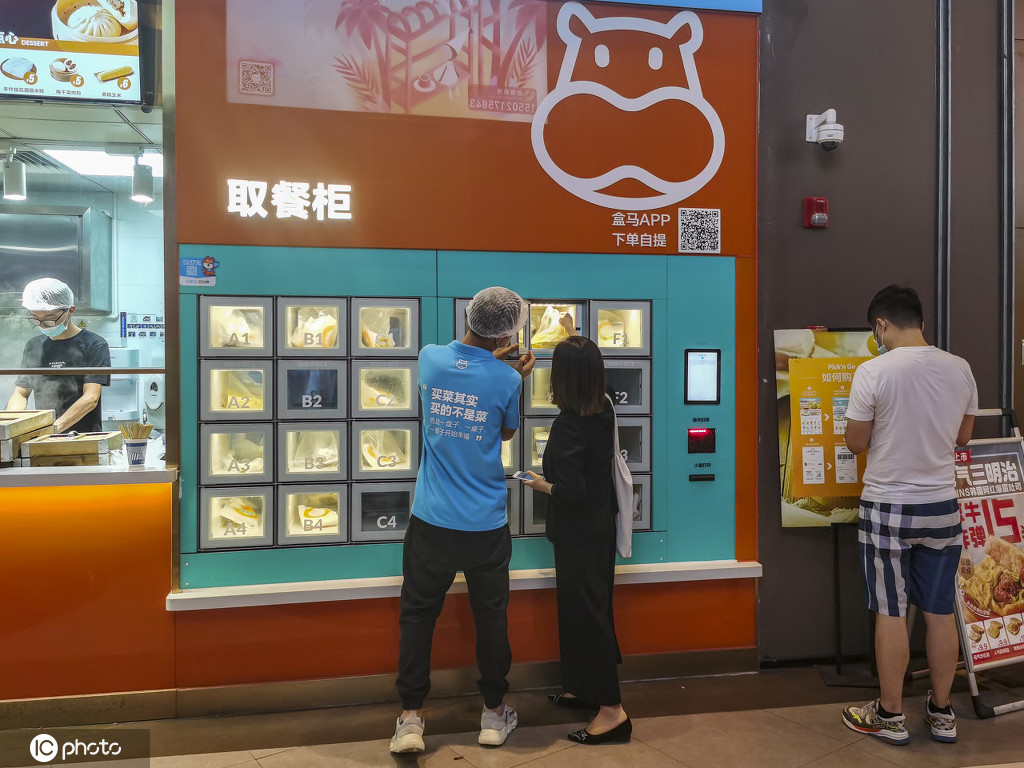 上海にオープンした「盒小馬」朝食店の1號(hào)店で店員にサポートされて朝食を受け取る利用客（寫真著作権は東方ICが所有のため転載禁止）。