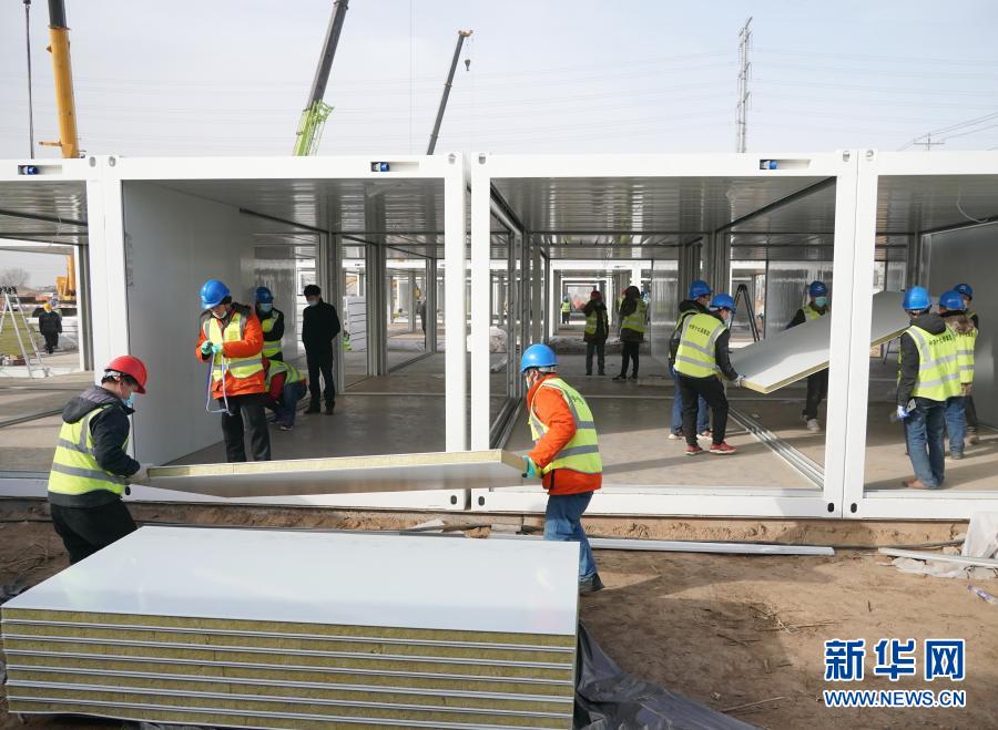 1月15日、集団隔離臨時施設(shè)?黃荘公寓のプレハブハウスを設(shè)置する作業(yè)員ら。（撮影：楊世堯）