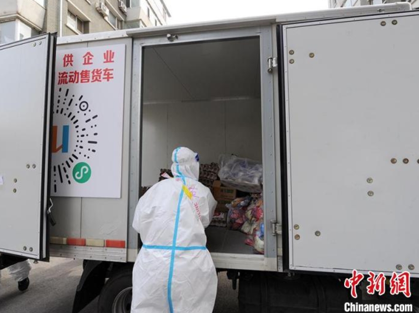 生活物資を運(yùn)搬する職員（撮影?劉棟）。