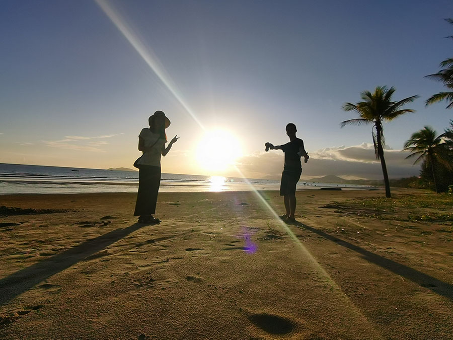 海南島の夕日をバックに