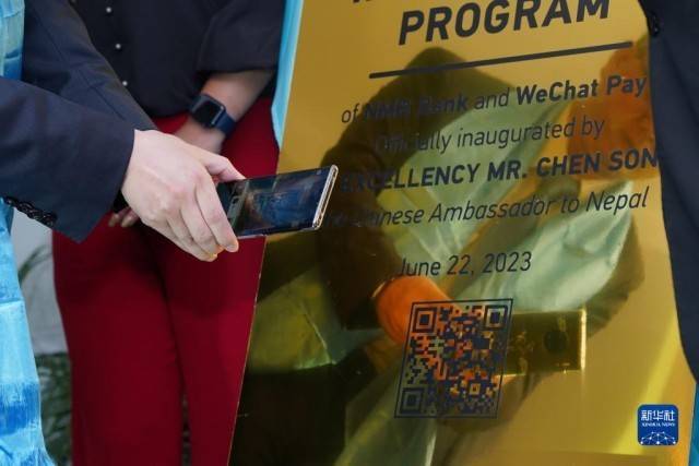 6月22日、ネパール有數(shù)の観光地ポカラで行われた微信支付（WeChatペイ）スタート式典で、出席者がQRコードをスキャンし、WeChatペイを體験する様子。