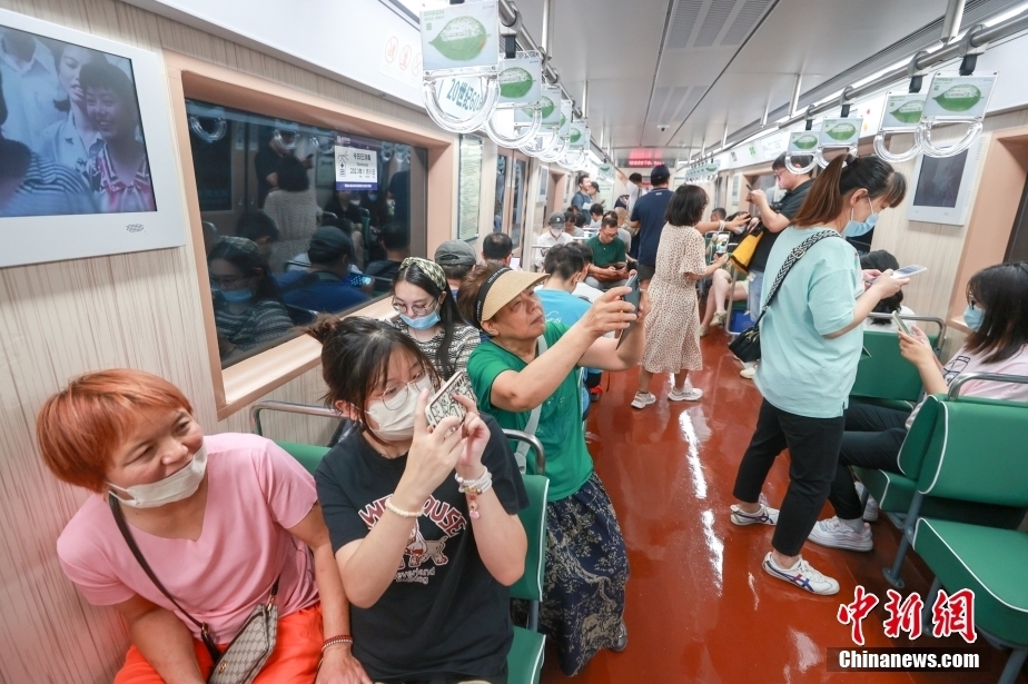 8月8日、車內(nèi)で記念寫真を撮影する乗客。（撮影?賈天勇）