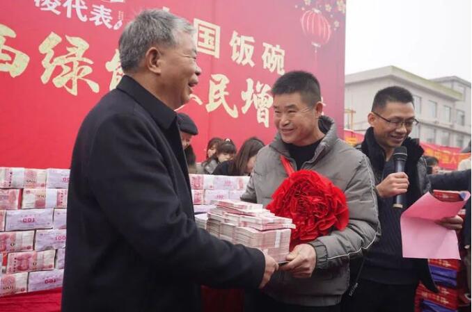 1月8日にボーナスを現(xiàn)金で支給する凌継河さん（寫真左、撮影?周密）。