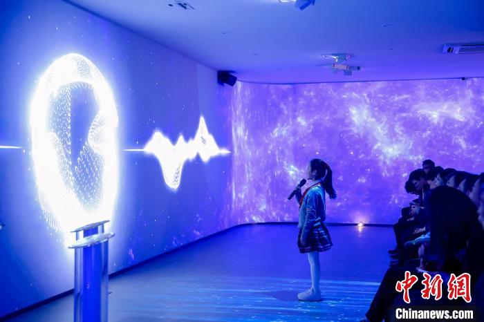 AIデジタルヒューマン「小無」と會話する女の子。