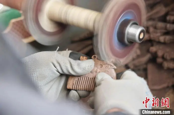 木製の櫛を磨き上げる職人（撮影?許伝寶）。