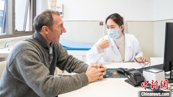 醫(yī)療スタッフと言葉を交わすデイビッドさん（撮影?龔傑）。