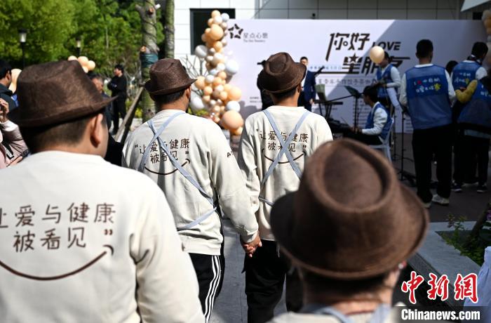 開業(yè)セレモニー參加のため、ステージに上がる準(zhǔn)備をする自閉癥の若者たち（撮影?呂明）。