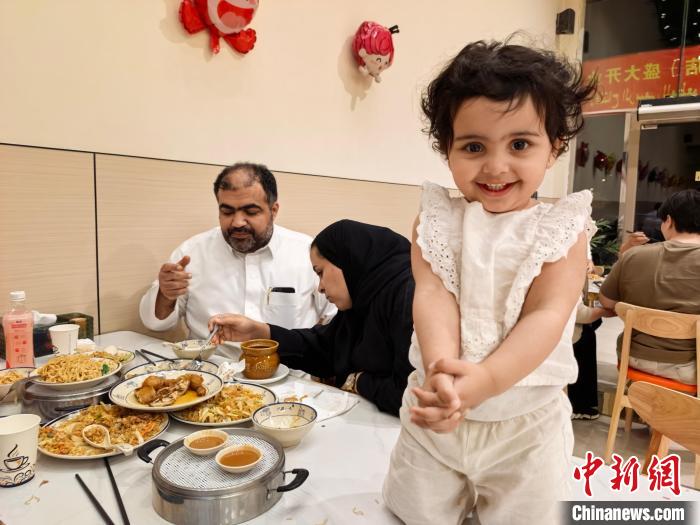 「沙県小吃」の料理を食べるサウジアラビア人家族（5月11日撮影?張世超）。