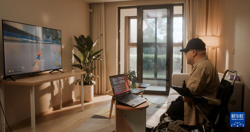 4月30日、上海の自宅でBMIによりレーシングゲームをプレイする被験者。撮影?戴焱淼