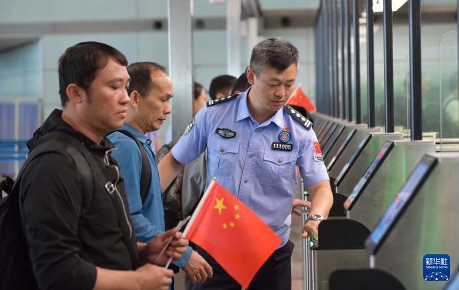 入國優(yōu)先レーンで入國する乗客をサポートする北京出入國検査所総ステーションの警察官（6月22日撮影·祖國寶）。