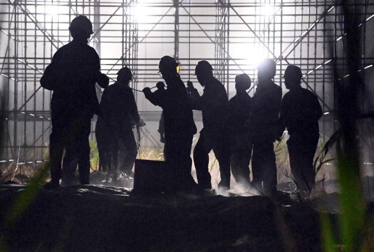 7月10日未明、塔里木（タリム）盆地の750キロワット送変電プロジェクトが同自治區(qū)の和田（ホータン）市と若羌（チャルクリク）県を結(jié)ぶ「和若鉄道」の線(xiàn)路をまたぐ區(qū)間で、送電線(xiàn)を被覆する作業(yè)を行う電力工事?lián)?dāng)者。