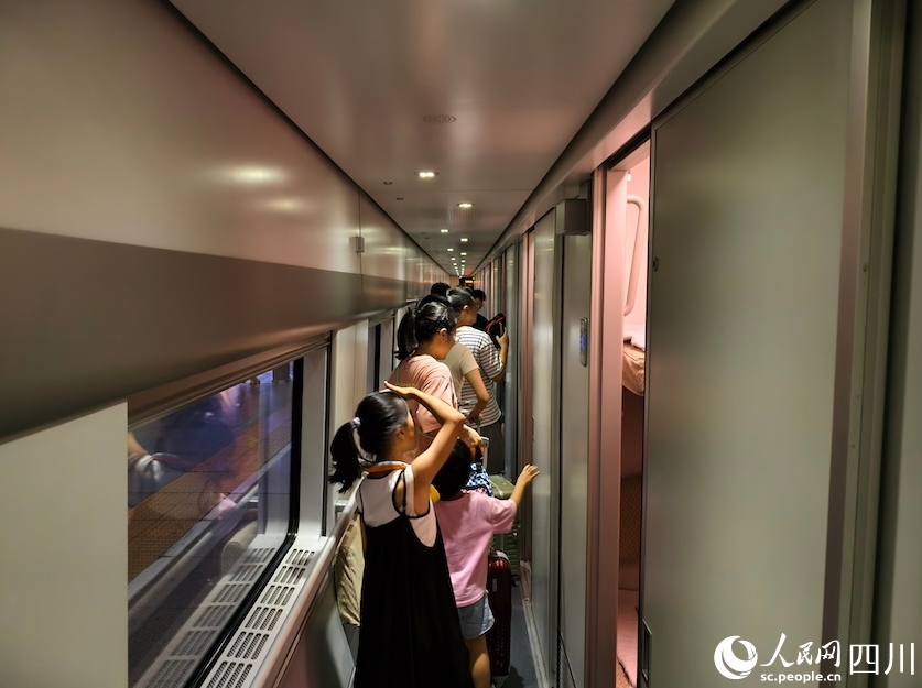 出発前のD966號車內(nèi)を歩く子供連れの旅客（7月31日撮影?郭瑩）。